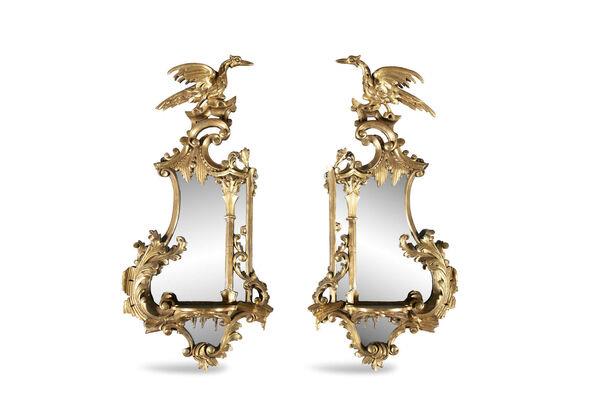 A pair of mirrored wall brackets with ho ho birds at James Adam. A pair of mirrored wall brackets with ho ho birds at James Adam.